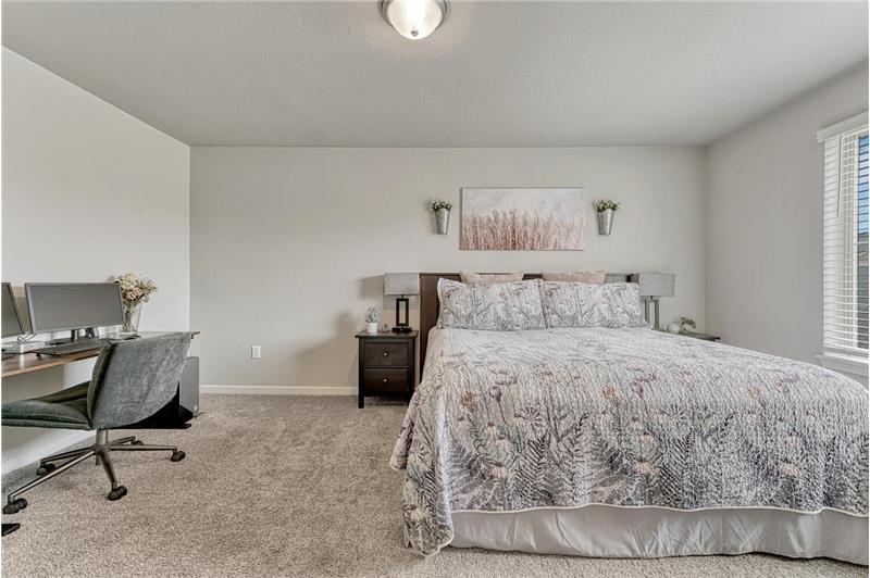 The Primary Bedroom has spacious room for a private sitting or desk area.