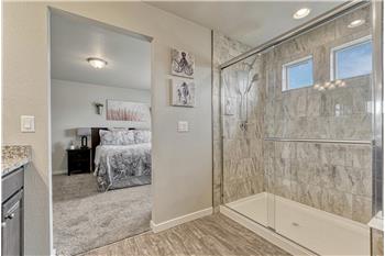 Gorgeous, enclosed tiled shower.
