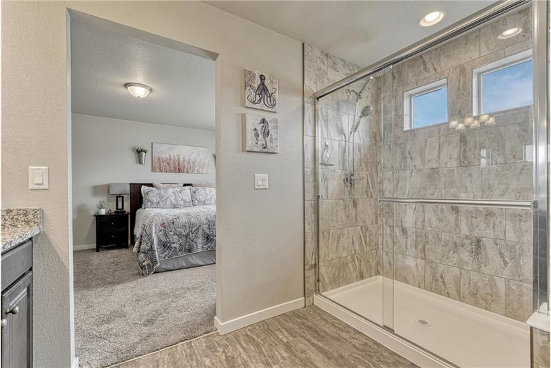 Gorgeous, enclosed tiled shower.