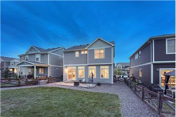 Sunset rear view of home and backyard.