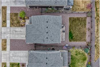 Aerial view of home, roof, and lot.
