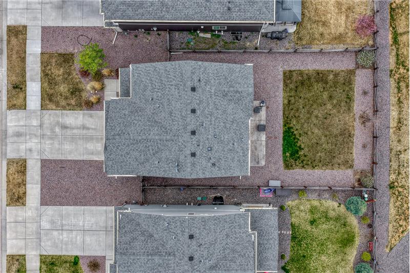 Aerial view of home, roof, and lot.