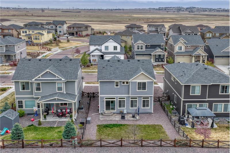 Sunset view of backyard grass area surrounded by xeriscaped beds.