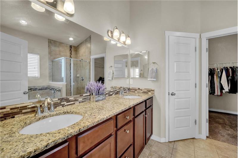 The 5pc Master Bathroom features a tile floor, a double sink vanity with granite countertops, and a walk-in closet