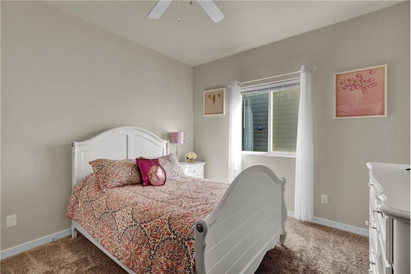 French doors lead into the main level Bedroom #3 with carpet and a lighted ceiling fan