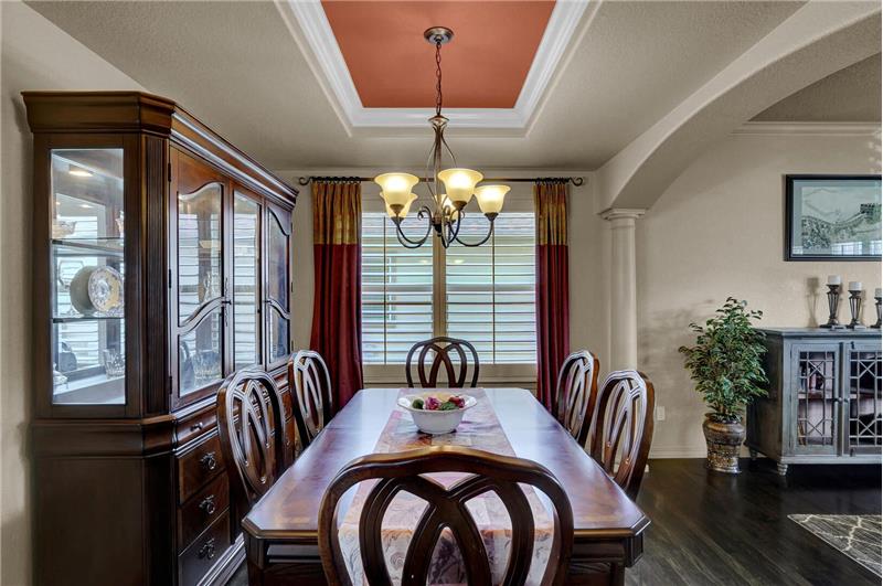 Formal Dining Room with tray ceiling and attractive light fixture