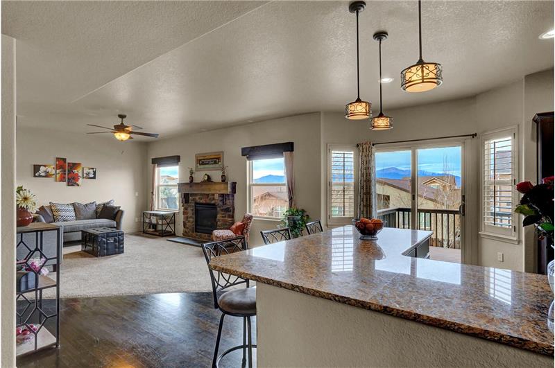 Family Room and Kitchen with walkout to an upper-level deck that enjoys amazing Pikes Peak views