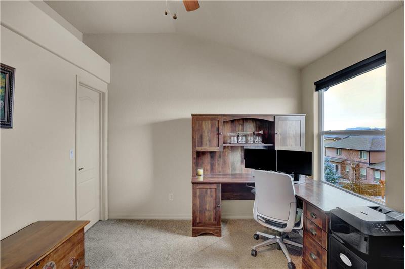 Upper-level Bedroom #4 (currently an office) offers a walk-in closet and Peak view