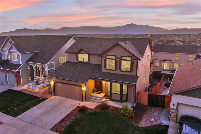 Aerial sunset view of the front of the home with Peak views in the rear