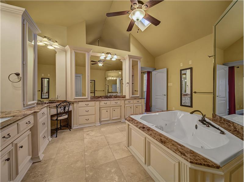 Primary Bathroom with vanity, a bath, high vaulted ceiling, tile patterned floors, and ceiling fan