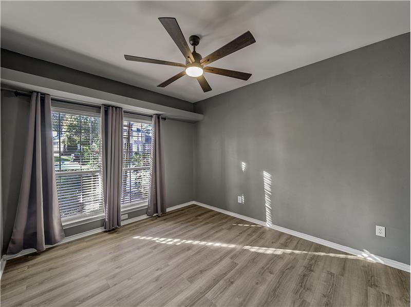 Bedroom #3 with ceiling fan and light hardwood style floors