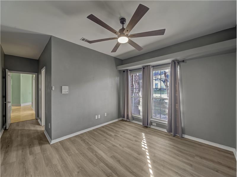 Bedroom #4 featuring hardwood / wood-style flooring and ceiling fan