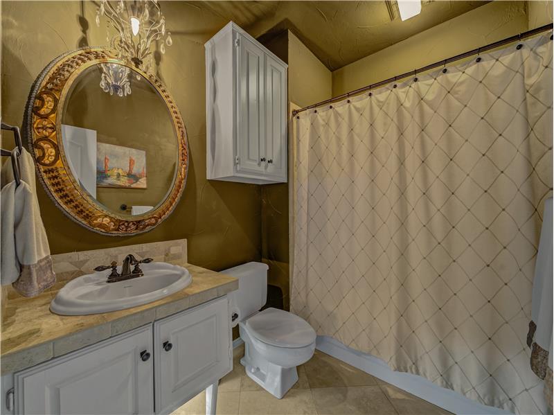 Bathroom featuring tile patterned flooring, vanity, and toilet