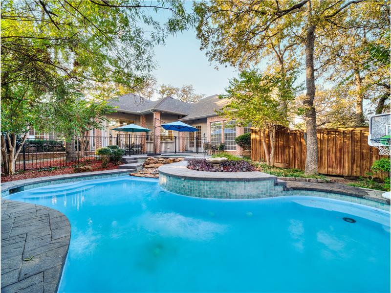 Very private backyard with lots of patio space and wrought iron fence! Lots of beautiful landscaping and large trees!