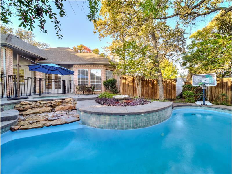 View of pool with water feature, and Jacuzzi hot tub!