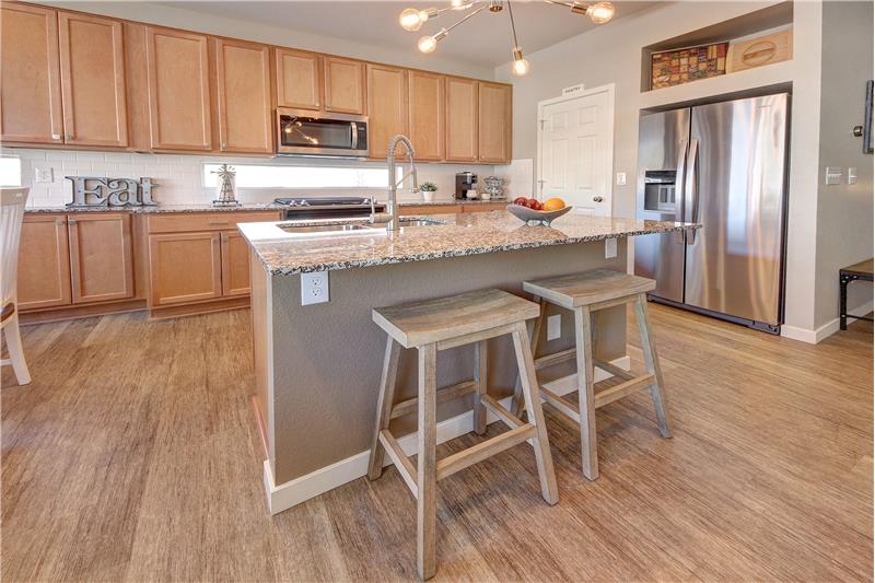Gourmet Island Kitchen with Stainless Steel Side by Side Refrigerator