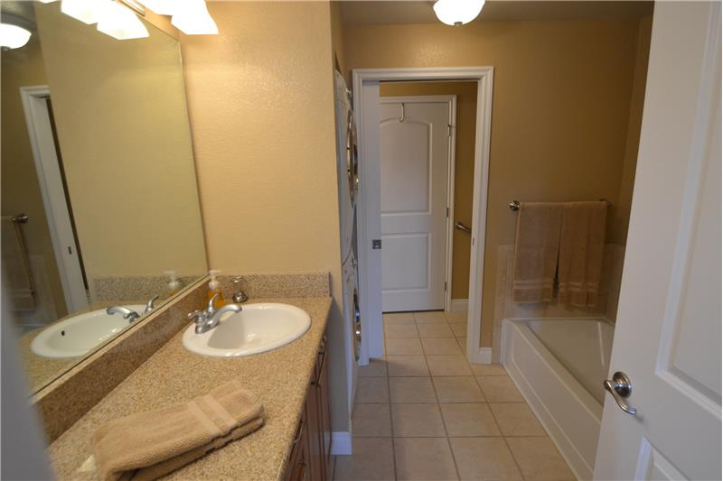 Master bathroom with pocket door to half-bathroom beyond