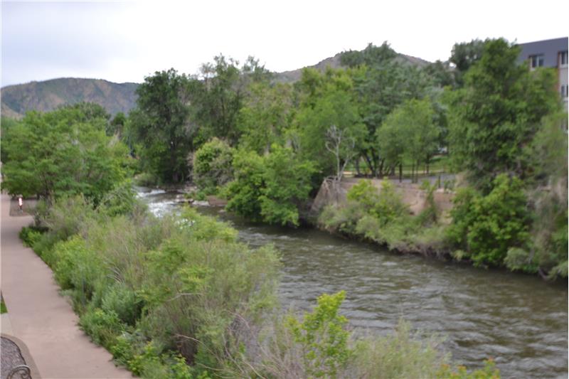 View of Clear Creek upstream with Parfet Park at right and foothills in the distance