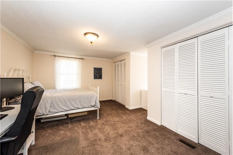 One of two additional bedrooms on second floor; two double closets provide excellent storage.