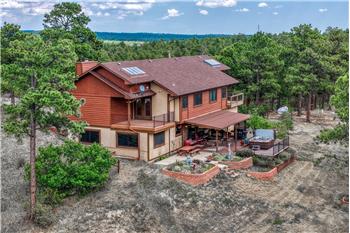 Nestled among towering trees on 5 horse-zoned acres, this one-of-a-kind property combines privacy, beauty, & amenities