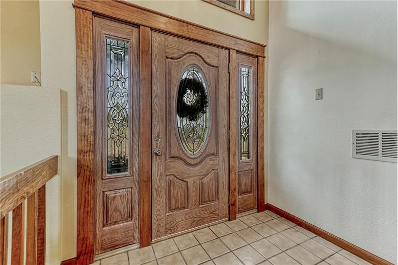 Elegant front door with sidelites and lead glass inserts.