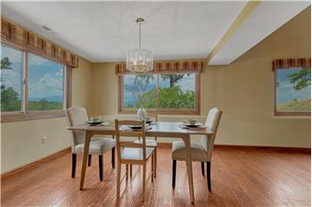 The Formal Dining Room is surrounded by windows and fill the home with natural light and frame spectacular views.