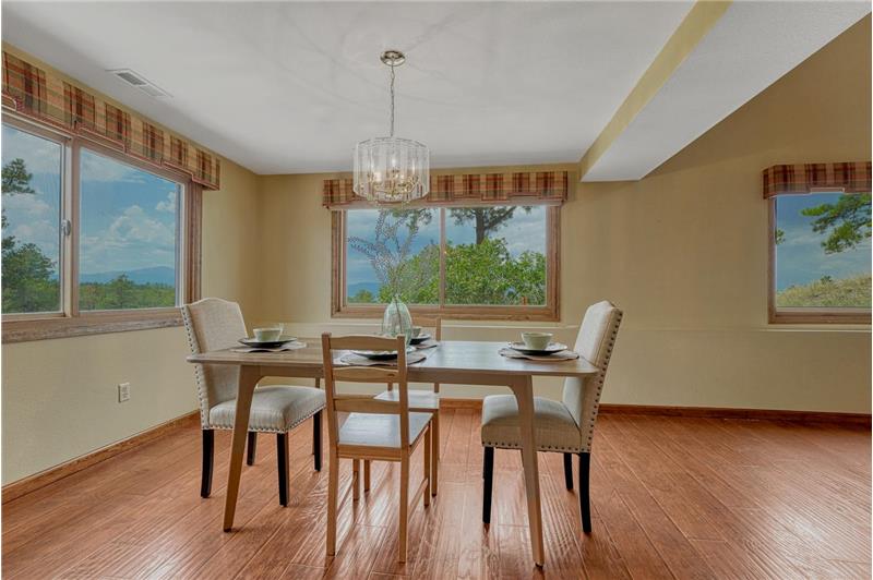 The Formal Dining Room is surrounded by windows and fill the home with natural light and frame spectacular views.