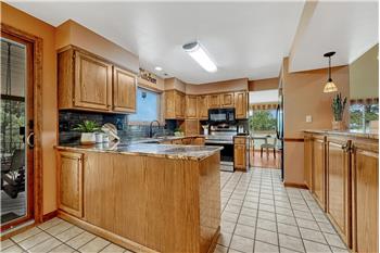 The updated Kitchen is a chef's delight with oak cabinetry, granite countertops and a full suite of appliances.