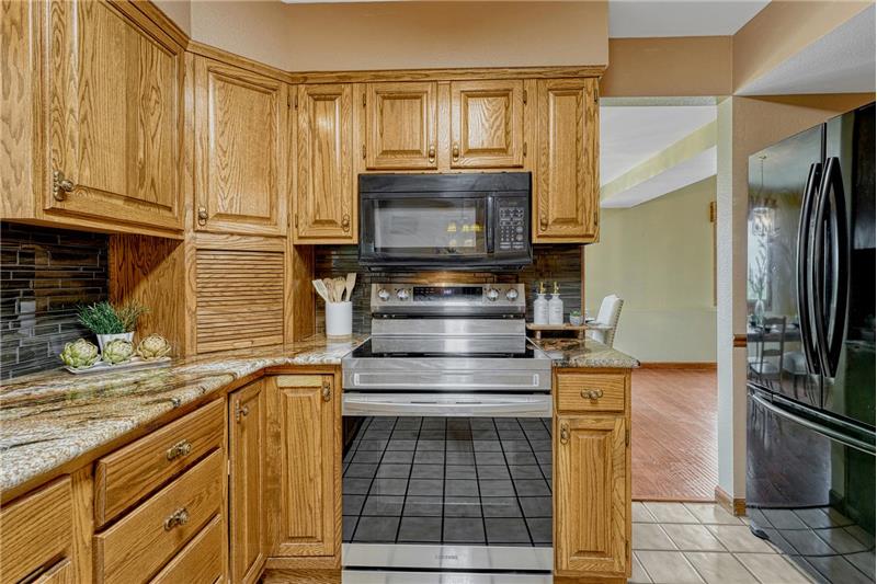 Smooth top range oven and overhead microwave oven.