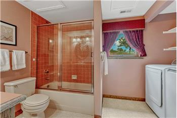 Main Level Bathroom with laundry area including the washer and dryer that stay.