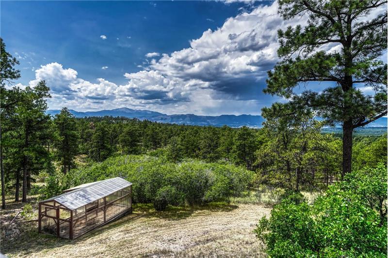 Glorious trees and mountain views with a greenhouse for growing your own food and flowers.