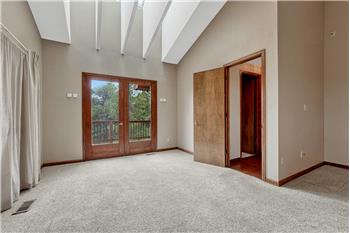 French doors from the Primary Bedroom to a private deck.