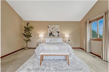 The expansive primary suite offers speaker wiring, skylights, auto shades, walk-in closet, and full bath with jetted tub/shower.