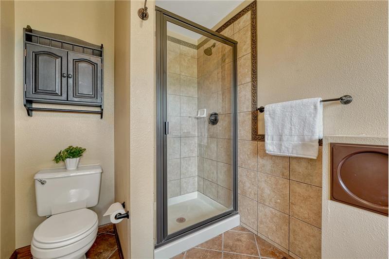 Tiled shower in the Primary Bathroom.
