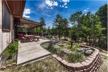 Expanded concrete patio and raised flower bed for the gardening enthusiast.