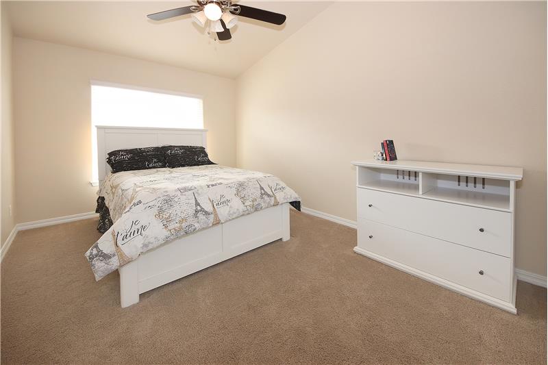 Bedroom 2 with vaulted ceilings and ceiling fan