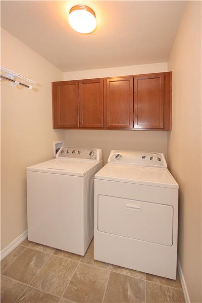Laundry room with cabinets and shelf with hanging rod.  Washer/Dryer included!