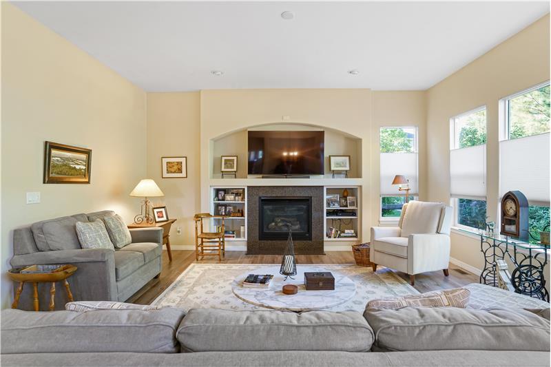 The wall-mounted TV above the gas fireplace is included.