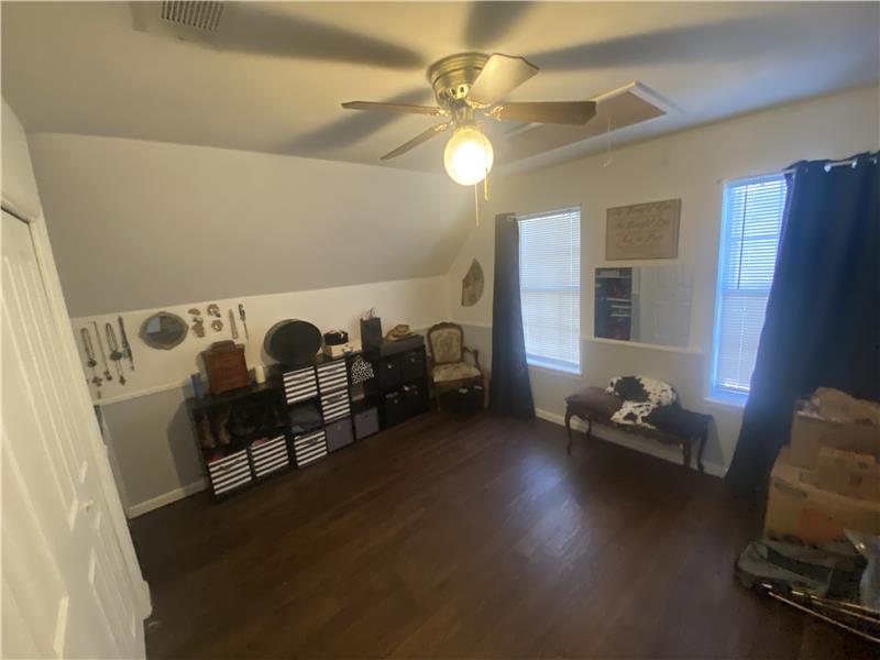 One of two bedrooms upstairs both have built in desk/shelves and closets