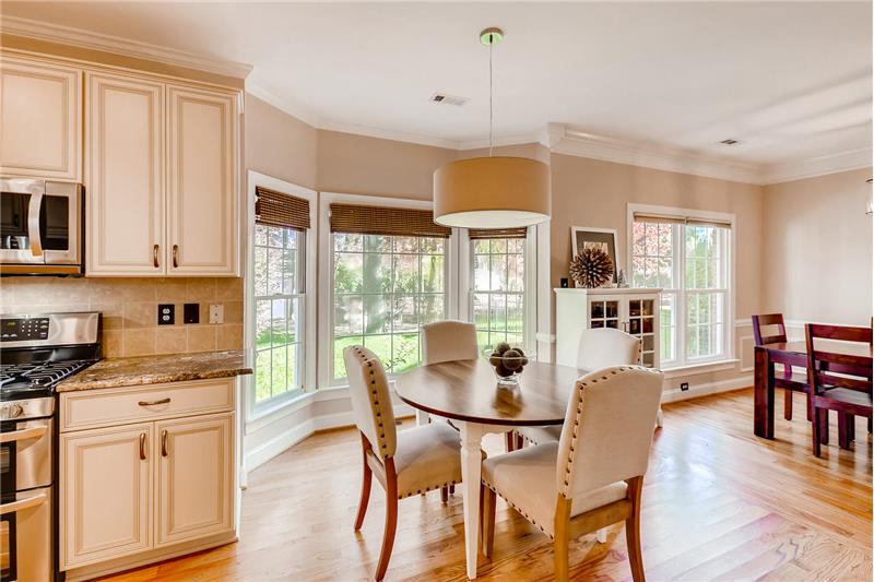 Sunny breakfast area nestled in a bay window ideal for daily meals and casual entertaining.