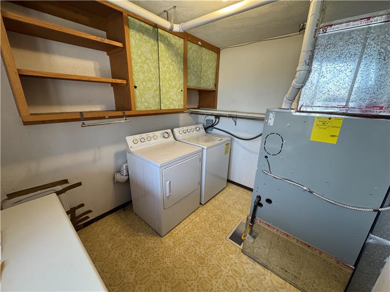 Laundry room off the family room. 95% efficient furnace & heat-pump water heater at right.