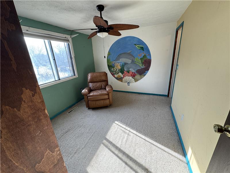Guest bedroom with carpeted floor and dolphin mural