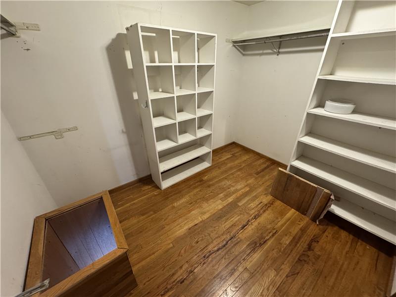 The large walk-in closet of the primary bedroom includes a laundry chute (left)