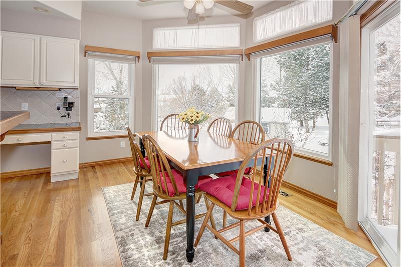 Breakfast nook with plentiful windows and walk-out to the back deck