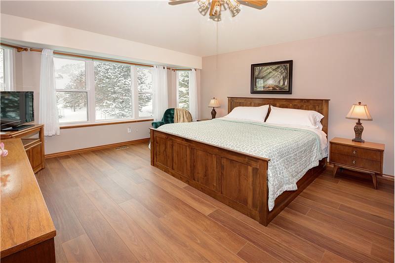 Master bedroom with updated windows and upgraded Cortex waterproof laminate flooring