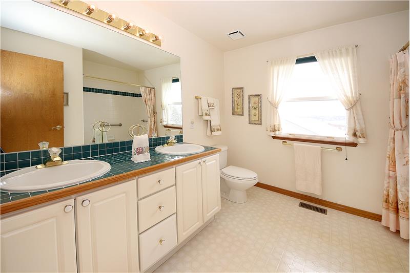 Large full bath on upper level with double sink vanity and a window!