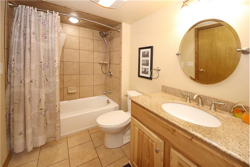 Full bath with tile and a ceiling heater