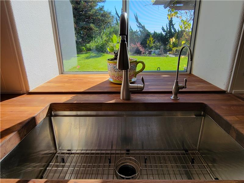 New Stainless Steel Farm Sink, Reverse Osmosis Water Filtration System AND Moen Garbage Disposal! Feel confident with this home!
