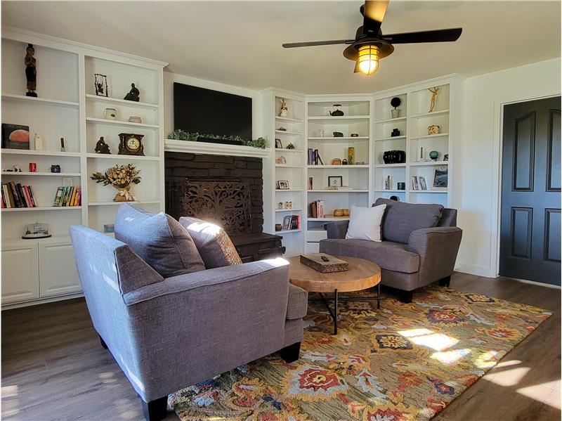 Stonecraft Ceiling Fan above Custom Built-in Floor to Ceiling Wrap-Around Book/Media Shelves in Family Room.