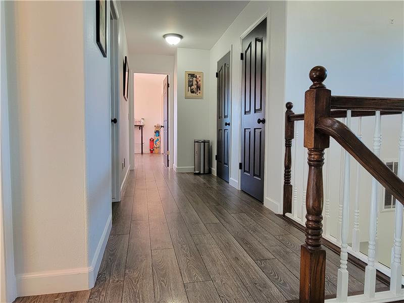 Spacious Hall providing doorways to both Linen Closet and Furnace Room/Attic STORAGE Access.